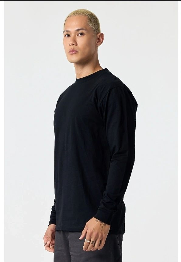 Model wearing a POUND long sleeve tee in an urban setting